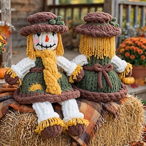 May include: Two handmade crochet scarecrow dolls featuring brown hats with green accents, yellow yarn hair, and orange noses. The dolls wear dark green dresses with white sleeves, yellow scarves, and brown shoes with yellow fringe details.