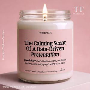 May include: A 255g soy wax candle in a clear glass jar with a lit wick. The pink label features the text: TWISTED FATE, The Calming Scent Of A Data-Driven Presentation, Smell that? That's flawless charts, confident delivery, and every graph telling your story.