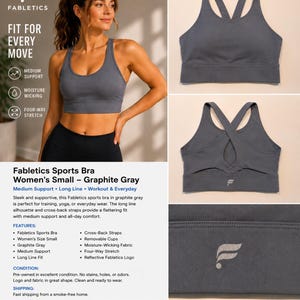May include: A graphite gray Fabletics sports bra featuring a long-line silhouette, a scoop neckline, and cross-back straps. The garment includes a reflective Fabletics logo on the back band. The fabric appears smooth with a solid matte finish.