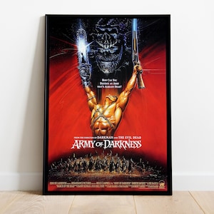 May include: A framed movie poster for Army of Darkness featuring a central figure with a chainsaw and shotgun raised against a red background. Above, a dark skull looms over the figure, while a skeletal army stands at the bottom of the poster.