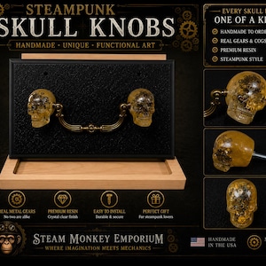 May include: Two amber-colored resin skull knobs with embedded metal gears, connected by a curved antique brass handle. The set is mounted on a black rectangular display board. Text on the image includes Steampunk Skull Knobs and Steam Monkey Emporium.