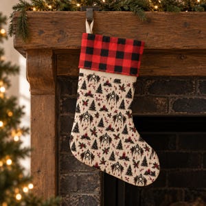 May include: A Christmas stocking featuring a red and black buffalo plaid cuff and a cream-colored body printed with a repeating pattern of dark green pine trees, red candles, and holly berries. The stocking includes a fabric loop for hanging.