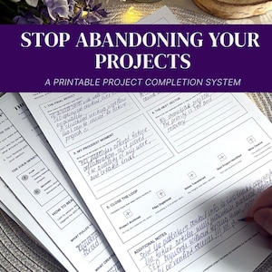 May include: A stack of white printable project completion system sheets with black text and lines. The top sheet features sections titled The Final Result, My Proudest Moment, The Next Vector, Close The Loop, and Additional Notes, with handwritten blue ink entries.