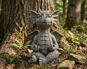 May include: A gray stone-colored dragon statue in a seated meditation pose with its eyes closed and hands resting on its knees. The dragon features textured scales, pointed ears, and small wings, depicted with a calm expression on its face.