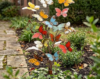 May include: A metal garden stake featuring multiple butterfly ornaments in various colors including red, yellow, orange, blue, and white. The butterflies are attached to thin, branching metal stems, creating a tree-like structure with a weathered finish.