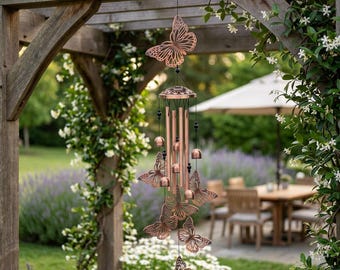 May include: A copper-colored wind chime featuring a large butterfly at the top and several smaller butterfly cutouts suspended by thin black strings. The chime includes multiple vertical metal tubes and small bells, creating a layered design.