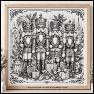 May include: A black and white cross-stitch pattern in a light wood frame featuring four nutcrackers standing among wrapped gifts, pine branches, and a lantern. The text at the bottom reads: 2026 CegaCrossStitch - Tous droits réservés / All rights reserved.