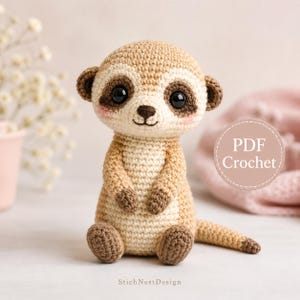 May include: A crocheted meerkat toy with tan and cream yarn, featuring large black safety eyes, a dark brown nose, and pink blush on the cheeks. A circular badge on the right side displays the text PDF Crochet. The base features the text StichNestDesign.