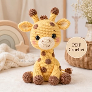 May include: A yellow and brown crocheted giraffe toy with black safety eyes, a white muzzle, and pink blush details on the cheeks. The giraffe features small horns, rounded ears, and brown spots on its head, neck, and body, sitting in a seated position.