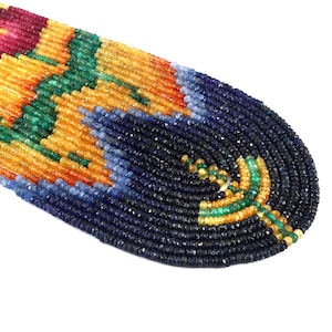 May include: A collection of faceted gemstone beads arranged in a curved, multi-strand pattern. The beads feature a vibrant gradient of colors including deep navy blue, bright orange, emerald green, and magenta pink, creating a smooth, flowing design.