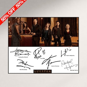 May include: A rectangular print featuring a cast photograph from the television show Lucifer, with six signatures below the image. The signatures are labeled with the names Lesley-Ann Brandt, Tom Ellis, Kevin Alejandro, D.B. Woodside, Lauren German, and Rachael Harris.