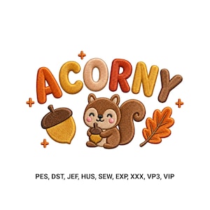 May include: An embroidery design featuring the word ACORNY in puffy orange, yellow, and brown letters. Below the text is a brown squirrel holding a small acorn, a large acorn, and an oak leaf. Small orange plus signs and file formats are included.