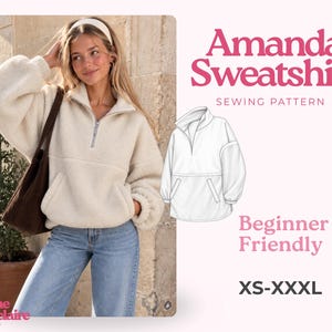 May include: A cream-colored, long-sleeved, quarter-zip fleece sweatshirt with a high collar and a front kangaroo pocket. The image includes a technical line drawing of the garment, the text Amanda Sweatshirt Sewing Pattern, and sizes XS-XXXL.