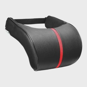 May include: A black faux leather neck support pillow featuring a textured surface and a vertical red stripe running down the center. The pillow includes an attached black elastic strap at the top for secure positioning and has a curved shape.