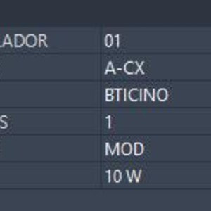 May include: A dark gray technical specification table with white text listing product attributes: CONTROLADOR 01, CIRCUITO A-CX, MARCA BTICINO, MODULOS 1, MODELO MOD, and CARGA 10 W. The header of the table is labeled Atributos in white text.