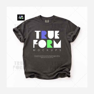 May include: A charcoal gray short-sleeve t-shirt with a crew neckline and rolled sleeves. The chest features the text TRUE FORM in large white letters, with the letter R in blue and the letter O in lime green, followed by the word MOCKUPS below.
