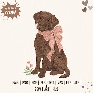 May include: An embroidery design featuring a brown Labrador retriever puppy wearing a large light pink bow around its neck, accompanied by a small flower sprig. The text reads AVAILABLE NOW and lists file formats EMB, PNG, PDF, PES, DST, VP3, EXP, JEF, SEW, ART, HUS.