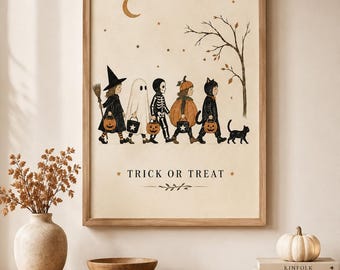 May include: A framed wall art print featuring a line of five children in Halloween costumes, including a witch, ghost, skeleton, pumpkin, and cat, walking past a bare tree under a crescent moon and stars, with the text TRICK OR TREAT below.