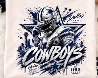 May include: A cream-colored crewneck sweatshirt featuring a graphic of a football player in a helmet and uniform, a large star, the Dallas skyline, and the text "Dallas Cowboys", "Cowboys", "We Dem Boyz!", and "Est. 1960" in blue and white.