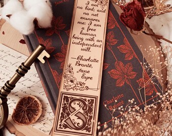 May include: A brown leather bookmark featuring a floral design and the quote "I am no bird; and no net ensnares me: I am a free human being with an independent will." - Charlotte Brontë, Jane Eyre. The bookmark also includes the letter "S" in a decorative font and the word "STORIARTS" at the bottom.