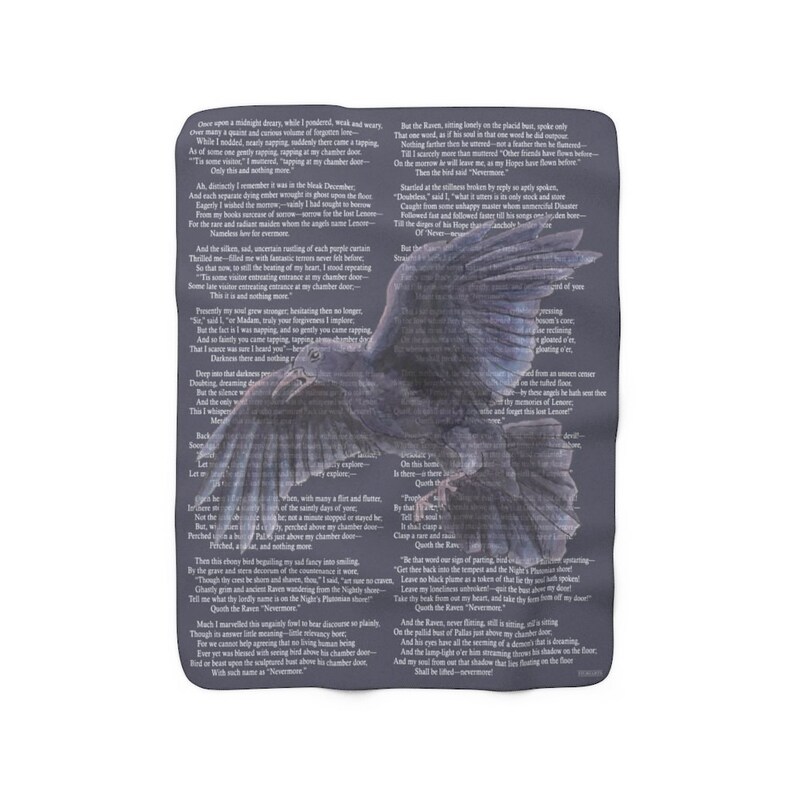 May include: A dark grey throw blanket with a large raven illustration and text from a poem. The raven has outstretched wings. The text is in a dark font and covers the background.