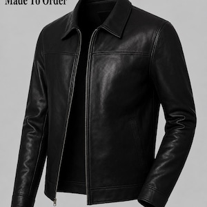 May include: A black leather jacket featuring a classic collar, a full-length silver-tone metal zipper closure, long sleeves with cuffs, and two side pockets. The text 'Made To Order' is printed in the upper left corner of the image.