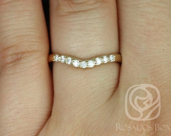 May include: A gold band with a curved row of small diamonds.