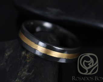 May include: A black and gold wedding band with a thin gold band around the center. The band is made of a dark metal and has a polished finish.