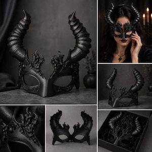 May include: A black masquerade mask featuring two large, textured, spiraled horns extending upward. The mask has intricate, raised filigree detailing around the eye openings and a smooth, contoured bridge. It is presented in a black gift box.