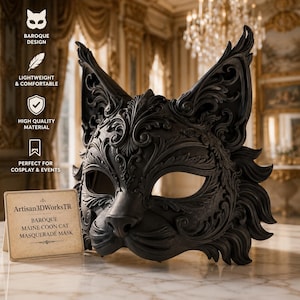 May include: A black Maine Coon cat masquerade mask featuring intricate scrollwork and pointed ears. A small rectangular sign next to the mask displays the text: Artisan3DWorksTR, Baroque MAINE COON CAT MASQUERADE MASK.