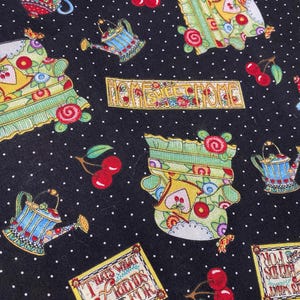 May include: Black fabric featuring a white polka dot pattern with repeating illustrations of green armchairs, blue watering cans, red cherries, and rectangular signs with the text HOME SWEET HOME and THATS WHAT FRIENDS ARE FOR in decorative lettering.