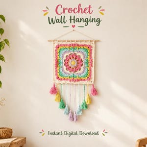 May include: A square crochet wall hanging featuring a central floral motif in pink, yellow, and lavender, surrounded by layers of teal, green, and pink yarn. The piece hangs from a wooden dowel with colorful tassels suspended from the bottom.