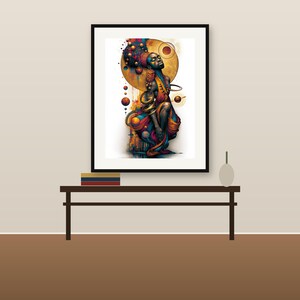 May include: A framed art print featuring a stylized figure with dark skin, adorned in vibrant orange, blue, and gold garments. The figure is surrounded by celestial spheres, rings, and abstract shapes against a white background, all enclosed in a black frame.
