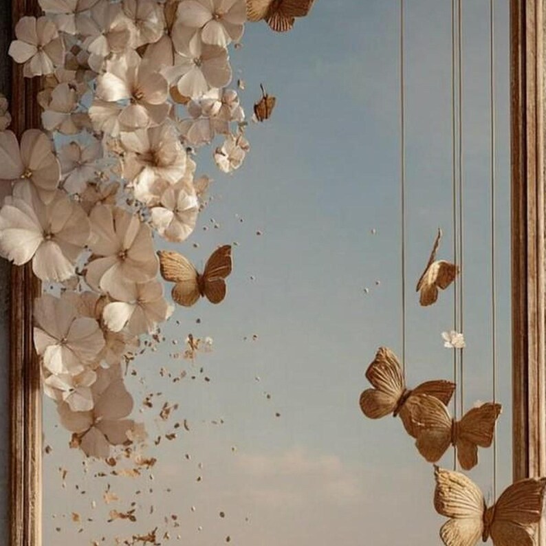 May include: A decorative wall hanging featuring a wooden frame with cascading cream-colored fabric flowers on the left side and several suspended, textured tan butterflies hanging from thin vertical strings on the right side.
