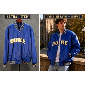 May include: A royal blue varsity jacket featuring the word DUKE in large, cream-colored block letters across the chest. The jacket has a snap-button front closure, long sleeves, and ribbed cuffs and collar with white and navy blue stripes.