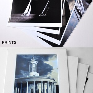 May include: A set of four prints, each matted to a standard 11x14 frame. The prints are black and white and feature a variety of subjects, including a sailboat, a building, and a cityscape. The prints are all matted in white.