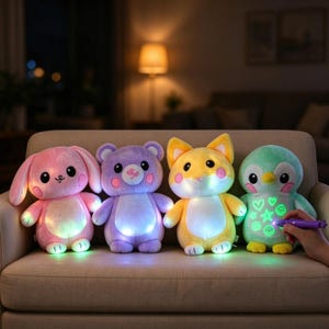 May include: Four plush toys sit in a row on a sofa. From left to right, a pink rabbit, a purple bear, a yellow fox, and a light green penguin. Each toy features glowing lights on its belly. A purple light pen is drawing glowing shapes on the penguin.