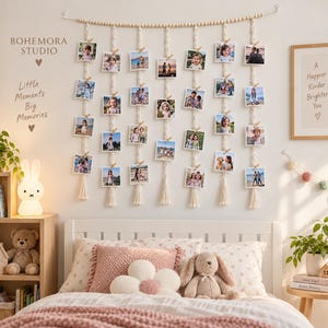 May include: A wall-mounted macrame photo display featuring seven vertical woven cotton cords suspended from a wooden bead rod. Each cord holds four square photographs attached with small wooden clips, finished with decorative tassels at the bottom.
