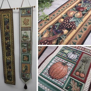 May include: Two vertical fabric wall hangings featuring woven autumn harvest designs. One displays a continuous pattern of fruits and grapes, while the other shows stacked square panels with pumpkins, gourds, leaves, and produce on a plaid background.
