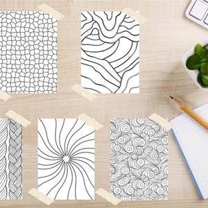 May include: Five rectangular sheets of white paper featuring black line art patterns, including a mosaic grid, wavy lines, a braided texture, a sunburst design, and swirling circles, each attached with small pieces of beige masking tape.
