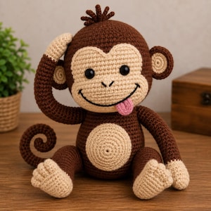 May include: A crocheted monkey stuffed animal with dark brown yarn for the body, limbs, and head, and light beige yarn for the face, ears, hands, feet, and belly. The monkey has black safety eyes, a stitched smile, and a small pink tongue sticking out.