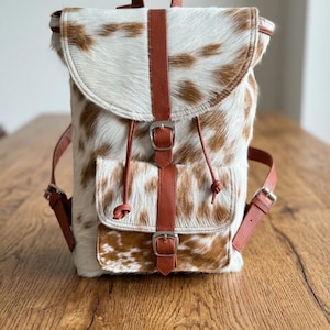 Handcrafted Cowhide Leather Backpack with Adjustable Straps and Front Buckle Pocket