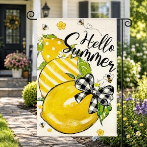 May include: A rectangular garden flag featuring three large yellow lemons with green leaves, a black and white buffalo plaid bow, and small bees. The text Hello Summer is printed in black script. The background is a light cream color.