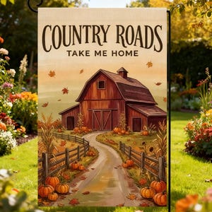 May include: A rectangular garden flag featuring a red barn at the end of a winding path. The text "COUNTRY ROADS TAKE ME HOME" is printed at the top. The scene includes orange pumpkins, wooden fences, and falling autumn leaves in shades of gold.