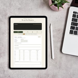 May include: A tablet displaying a digital planner titled The 90-Day Blueprint, featuring a weekly tracking layout with checkboxes, a white stylus pen, a laptop, and a small potted succulent plant on a textured gray surface.