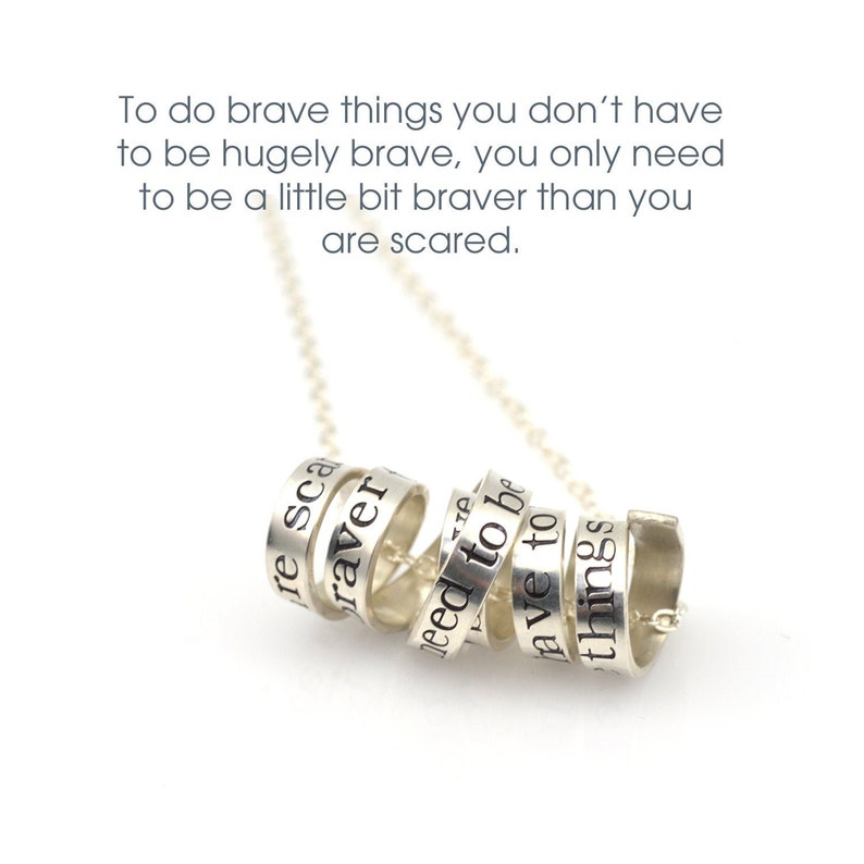 May include: Silver necklace with a quote inscribed on each ring: "To do brave things you don't have to be hugely brave, you only need to be a little bit braver than you are scared."