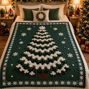 May include: A dark green crochet blanket featuring a large, textured Christmas tree design in the center with white, snow-like accents. The blanket is decorated with white snowflake motifs and has a scalloped border with white detailing.