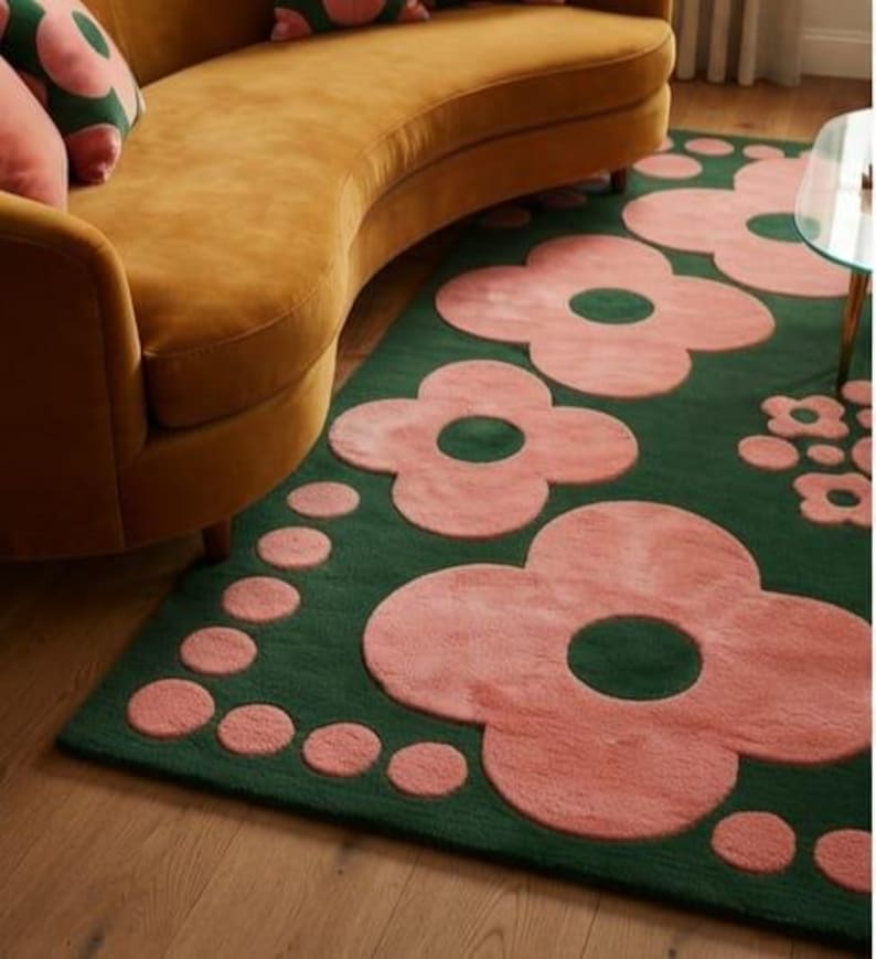 May include: A rectangular area rug featuring a deep forest green background with a repeating pattern of large, soft pink four-petaled flowers and smaller pink circular dots arranged in clusters across the surface of the floor covering.