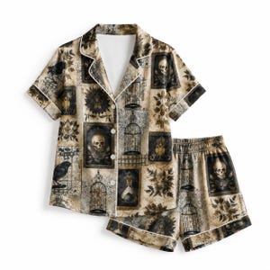 May include: A short-sleeve button-down pajama shirt and matching shorts set in a beige and black color palette. The fabric features a repeating pattern of skulls, birdcages, crows, and potion bottles, finished with white piping along the edges.