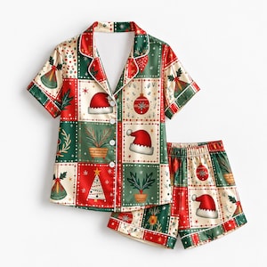 May include: A short-sleeve button-down pajama shirt and matching shorts set featuring a festive patchwork pattern. The design includes red, green, and cream squares decorated with Christmas trees, Santa hats, ornaments, and potted plants.